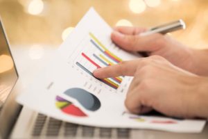 man reading over paper that measures marketing effectiveness