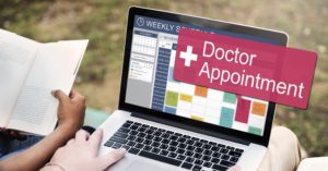 laptop on calendar page with scheduled doctor appointment