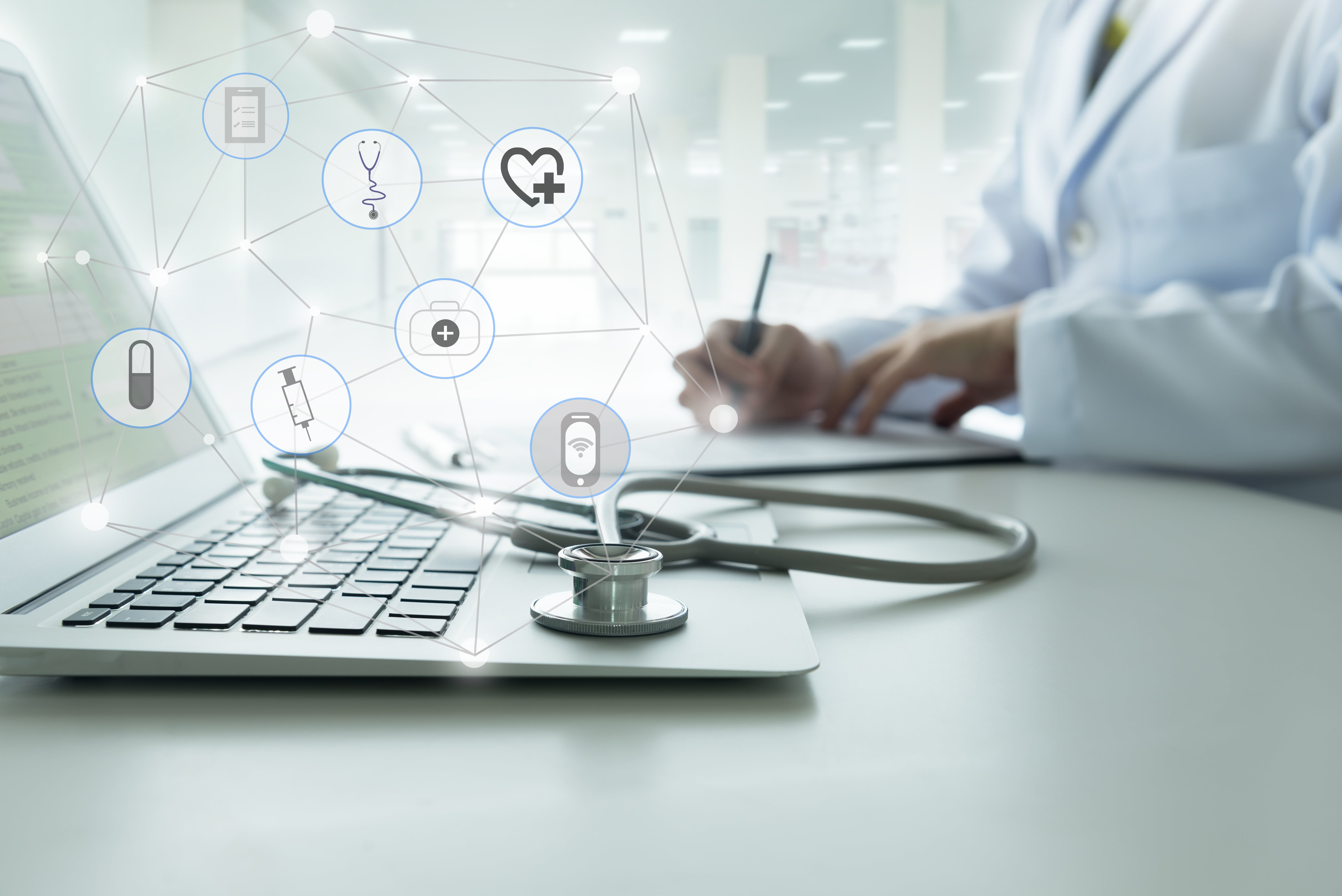 laptop and a stethoscope with animation of healthcare marketing strategy symbols