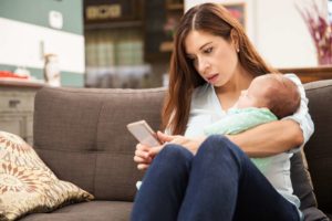 hispanic mom searching mobile marketing on phone