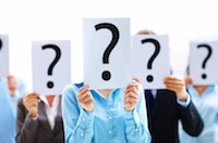 Business people standing with question mark on boards