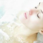 Woman with eyes closed enjoying the jacuzzi at a spa