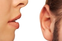 woman whispering into ear