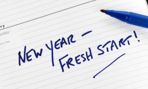 notepad with words reading "New Year-Fresh Start"