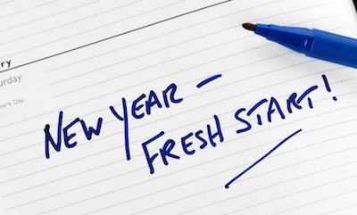 "New year, fresh start!" text in blue marker ink on planner calendar