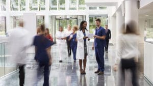 Staff In Busy Lobby Area Of Modern Hospital