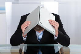 man holding laptop over head