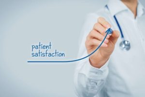 "Patient satisfaction" with an arrow pointing up written in blue ink by a doctor