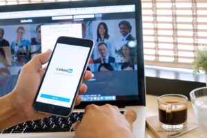 phone on linkedin app and computer on linkedin website