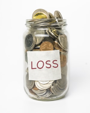 jar with "loss" label on it filled with coins