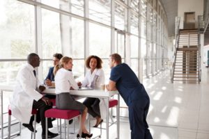 Doctors at a table discussing their work