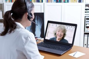 doctor providing telehealth services through laptop