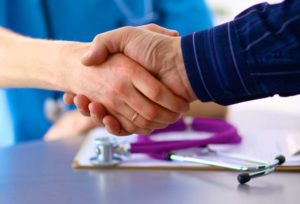 patient shaking hands with doctor out of trust